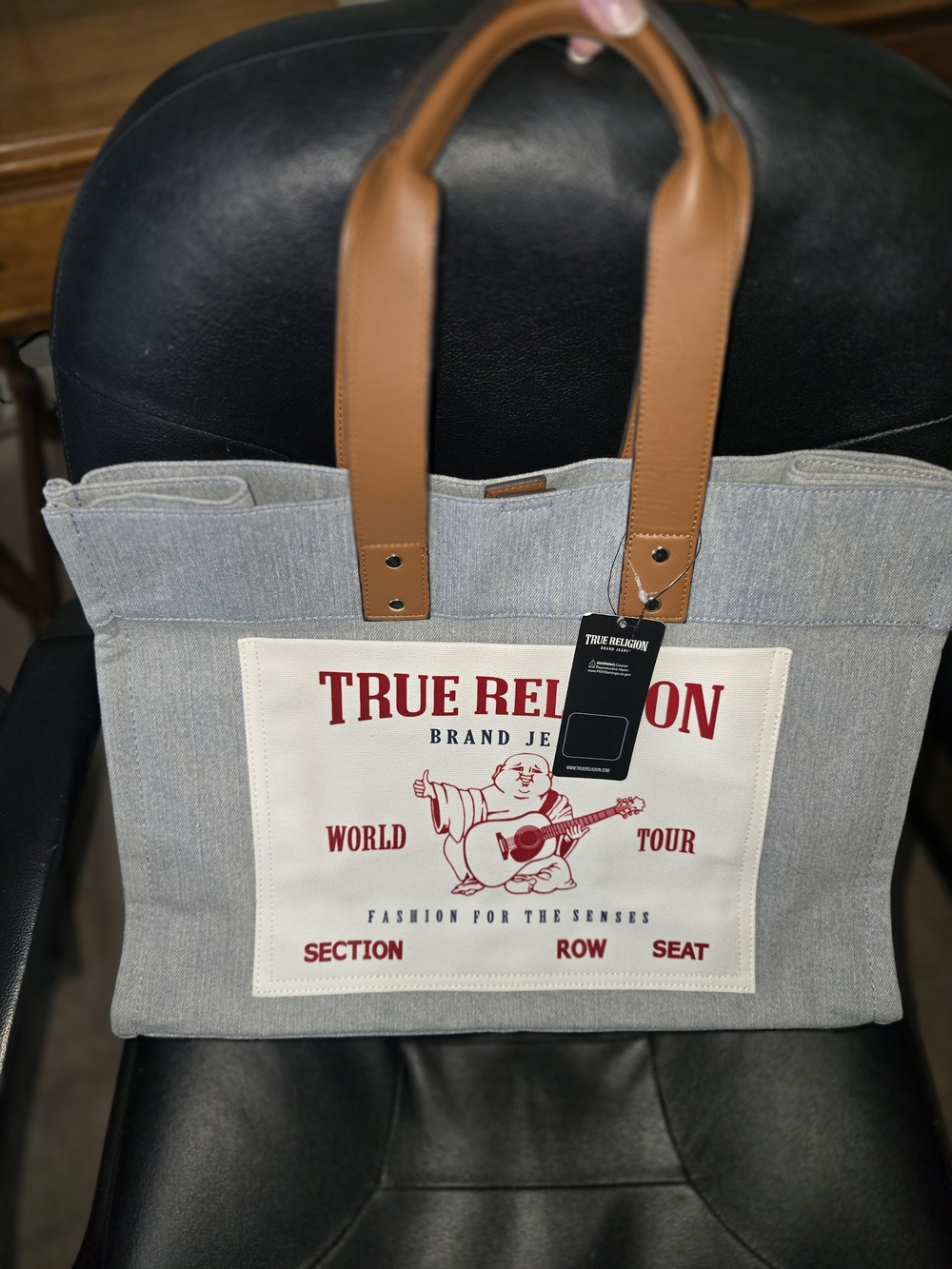 True Religion Light Denim Messenger Tote with Tan Leather Handles and Red Logo